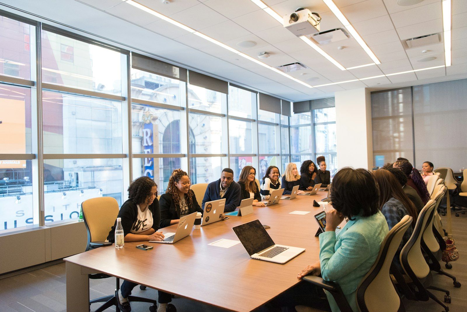 HR team meeting around a table with laptops