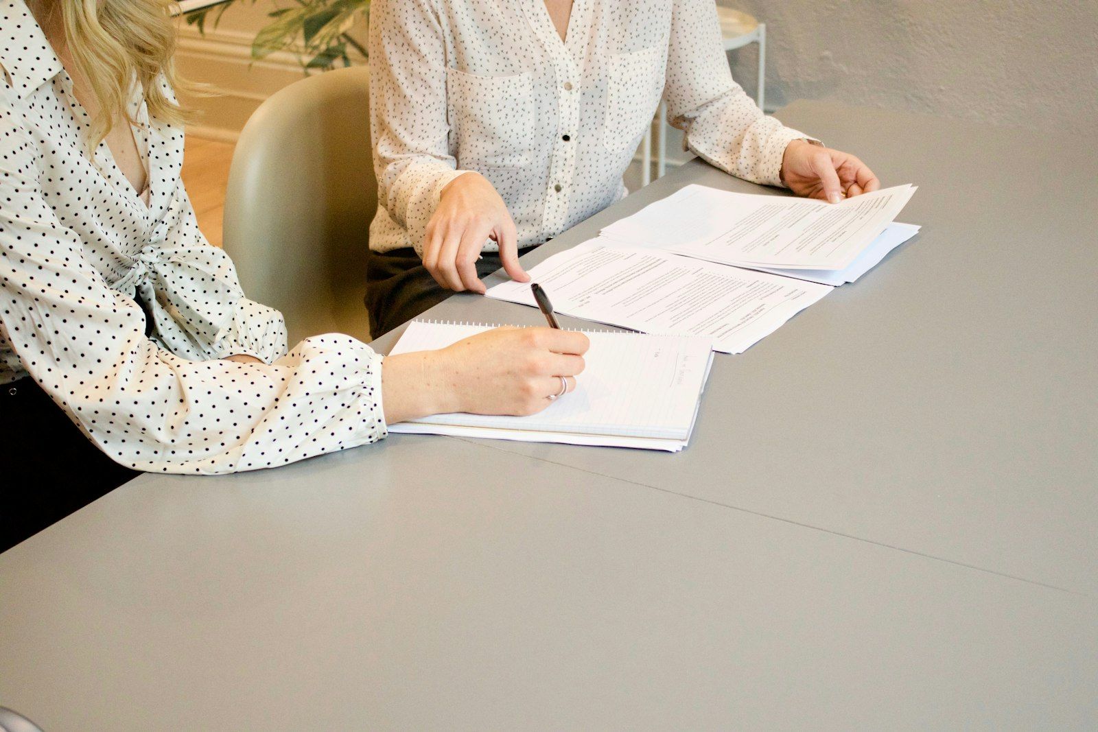 Two professionals reviewing and signing legal documents