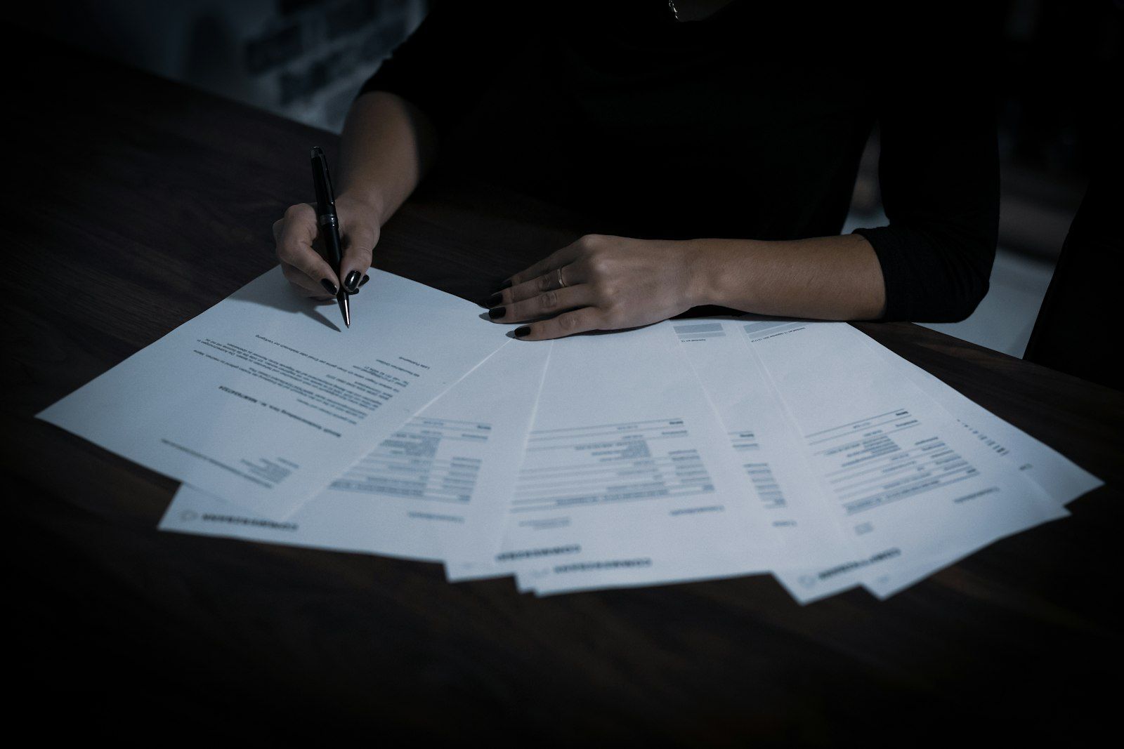 Professional reviewing audit documents at a table