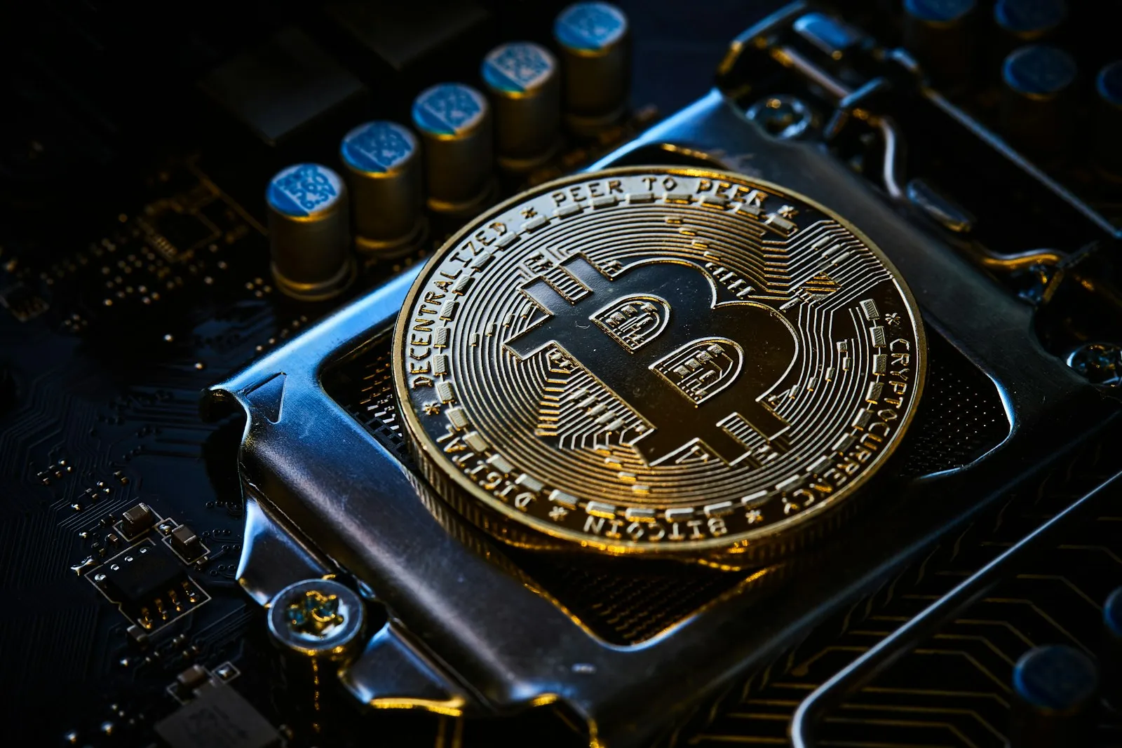 Bitcoin coin resting on a computer circuit board