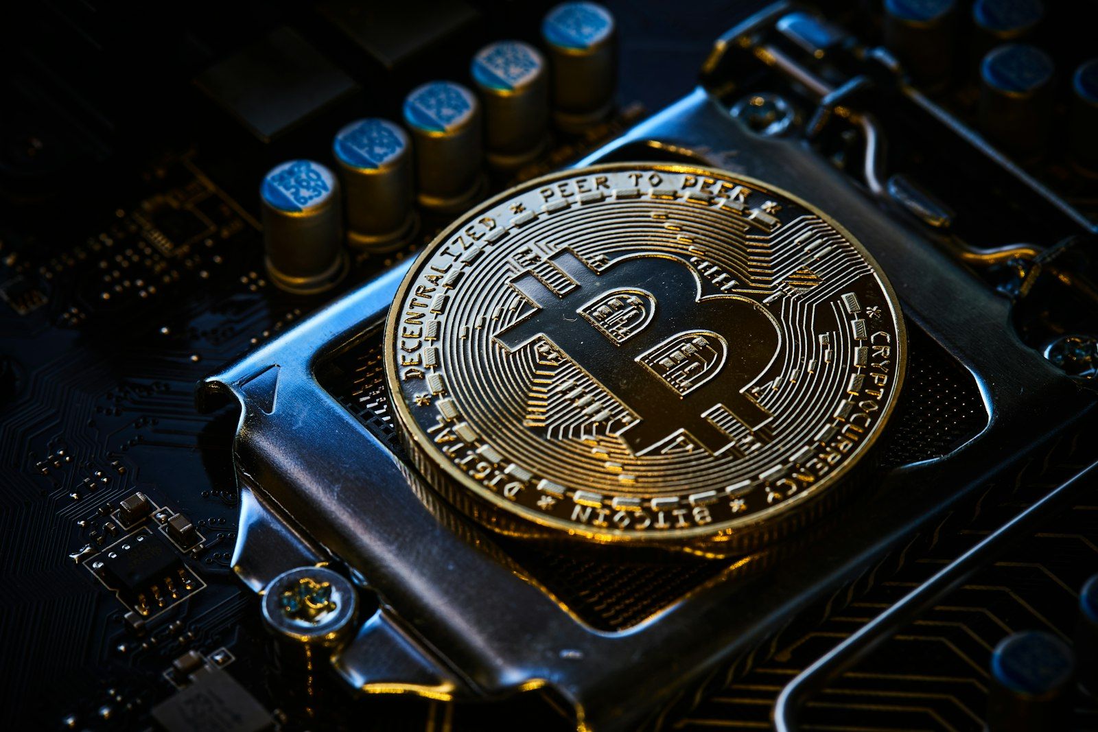 Bitcoin coin resting on a computer circuit board