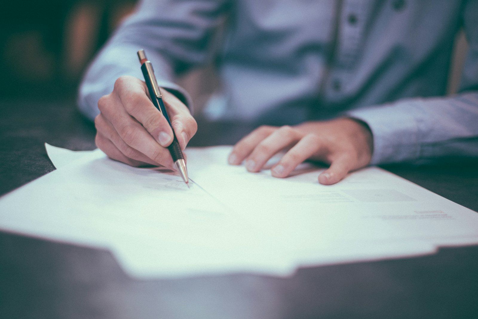 Legal professional reviewing and signing a document